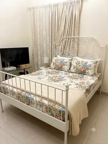 White Metal Double Bed Frame with Floral Bedding (IKEA-style)