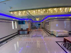 Two-bedroom apartment with a living room and private parking available for annual rent on Khalifa St