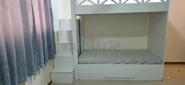 White wooden bunk bed with built-in steps and storage, single size