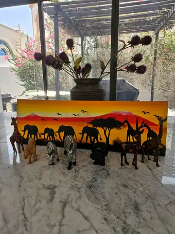 African sunset canvas with carved wooden animal set