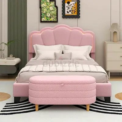 Pink upholstered queen bed with scalloped headboard