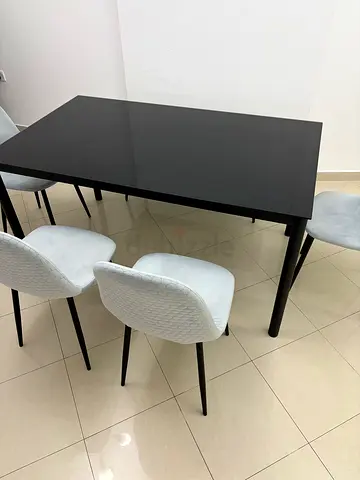 Modern black dining table with 4 grey upholstered chairs, 1 dining bench.