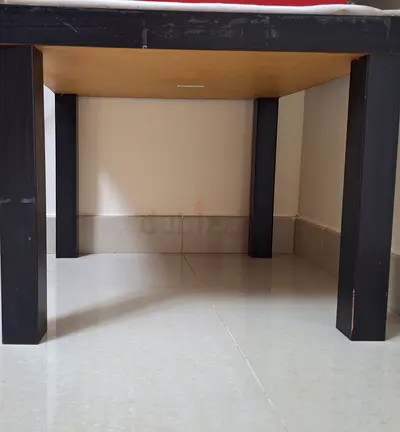 Simple wooden table with black legs - good condition