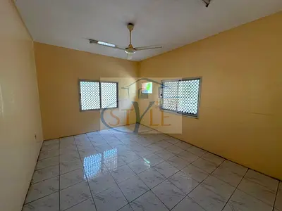 For rent: two rooms, a living area, two bathrooms, and a spacious courtyard. Unfurnished (no A/C). Spacious layout and prime location.