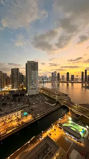An apartment in Al Khan featuring a direct view of Al Khan Lake and another view of the Qasba Canal.