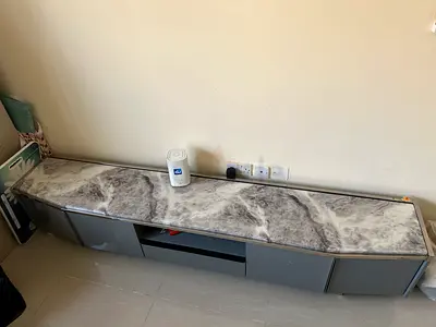 Low modern TV cabinet / entertainment unit with marble-effect top