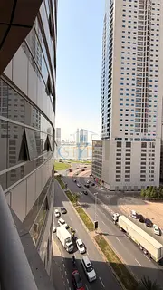 An apartment in Al Khan featuring a direct view of Al Khan Lake and another view of the Qasba Canal.