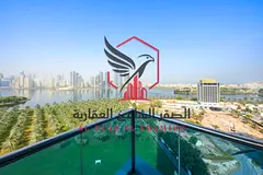 Luxury sea view in Al Majaz with a balcony and the largest space a three-bedroom apartment with a li