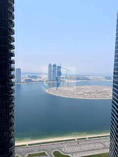 An apartment in Al Khan featuring a direct view of Al Khan Lake and another view of the Qasba Canal.