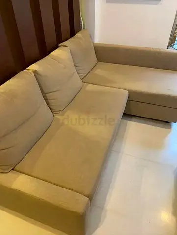 L-shaped beige fabric sofa — 3-seater with chaise