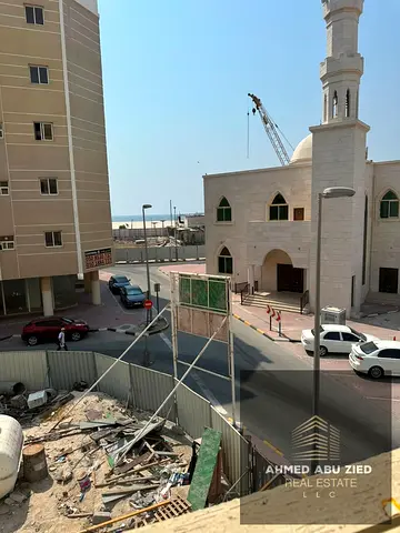 Investment building for sale in Al Nakheel 2, Ajman, near Ajman Corniche. 26 residential units, sea