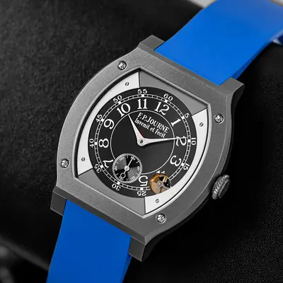 This is an F.P. Journe Élégante watch featuring a titanium case and a distinct bright blue rubber st
