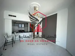 **Spacious 1-Bedroom Apartment for Annual Rent – Al Majaz 3, Sharjah.** Modern open-plan kitchen,