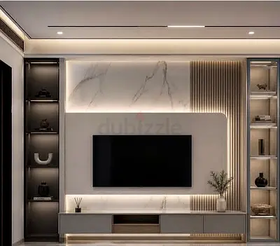 Modern built-in entertainment unit with marble back panel and LED lighting
