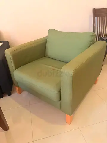 Green fabric single armchair with wooden legs
