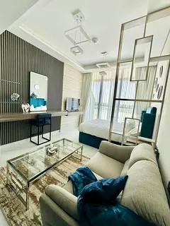 Designer’s fully  furnished & equipped unit with balcony & covered parking