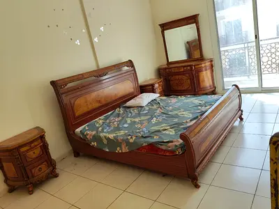 Classic wooden bedroom set — double bed with dresser and bedside tables