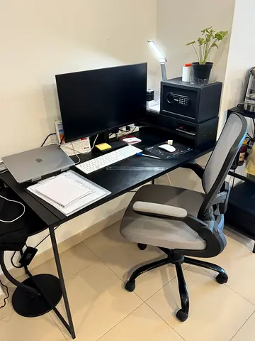 Black compact home office desk with ergonomic chair and shelving