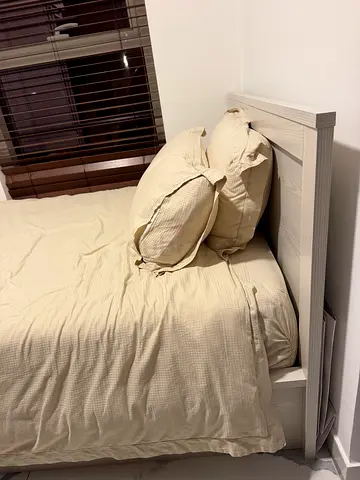 Single bed with mattress and sheets