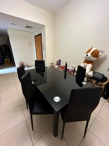 6-seater black glass dining table with upholstered chairs