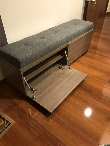 Padded storage bench with wood finish