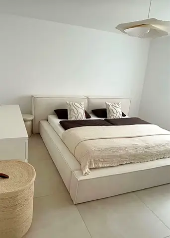 Low-profile modern platform bed with upholstered headboard
