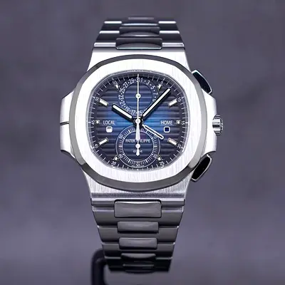 This Patek Philippe Nautilus Travel Time Chronograph features a distinctive blue sunburst dial and d