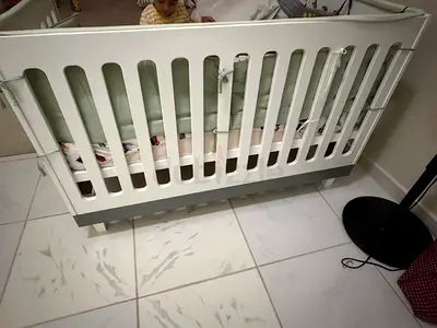 White wooden baby crib in good used condition