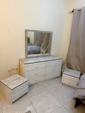 White wooden bedroom dresser set with mirror and bedside tables