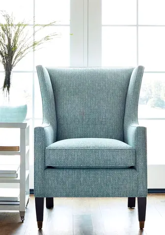 Light blue upholstered wingback armchair