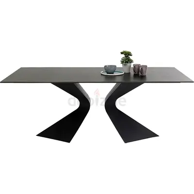 Modern black metal dining table with sculptural base
