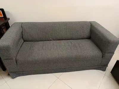 Three-seater grey fabric sofa in good condition