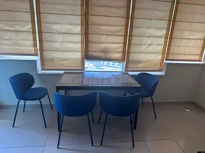 Dining table with four blue upholstered chairs - good condition