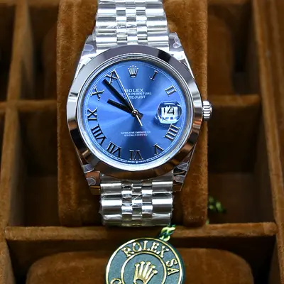 This is a Rolex Datejust 41, featuring a striking blue sunburst dial with Roman numerals.