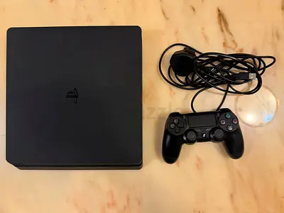 PlayStation 4 Slim console with DualShock 4 controller and power cable - working condition