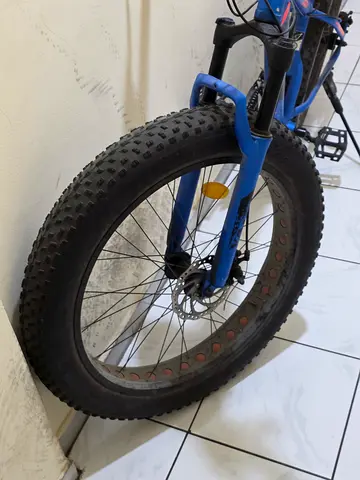 Used blue mountain bike with fat tyres — good for off-road trails