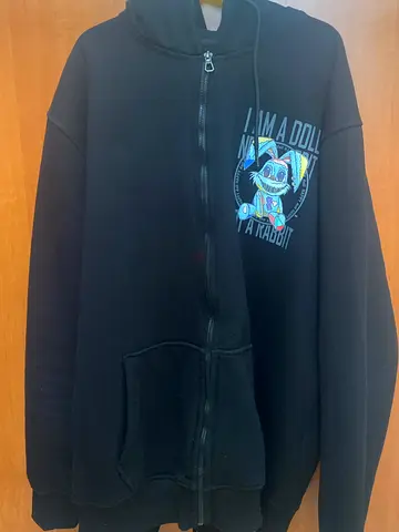Black zip-up hoodie with graphic print, size M