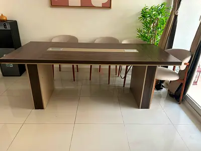 Large modern wooden dining table with cable management slot