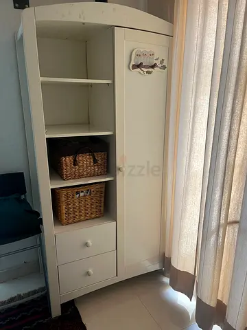 White freestanding storage cabinet with shelves and drawers
