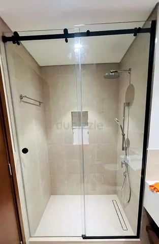 Glass sliding shower enclosure with matte black hardware -  New