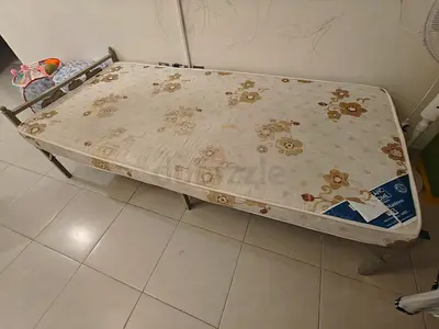 Single Metal Bed Frame with Mattress. The bed is sturdy and fully functional.