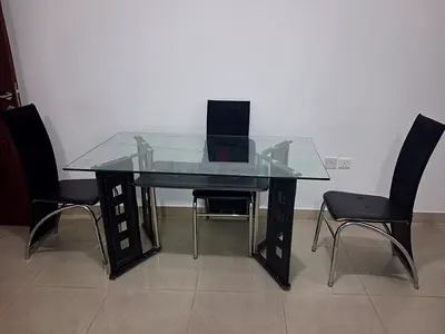 Glass Top Dining Table with 6 Modern Black Chairs - Fair Condition 80x140cm