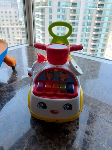 Baby push-along activity walker with music and pop-up rollers