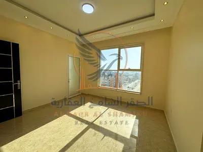 Apartment for rent in Al Rawda, three rooms and a hall with three bathrooms, high-end finishing, central air conditioning, luxury building, private pa