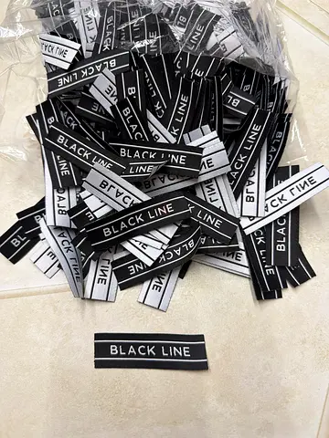 Lot of 'BLACK LINE' clothing woven labels - new, many pieces