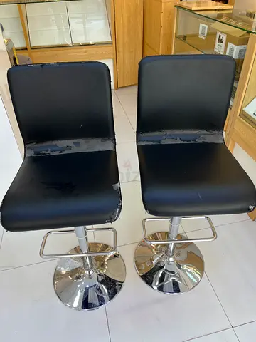 Pair of black swivel bar stools with chrome bases — used