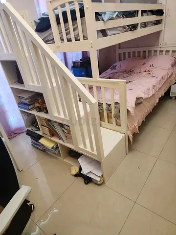 White wooden bunk bed with storage stairs - good condition. Come with two matresses