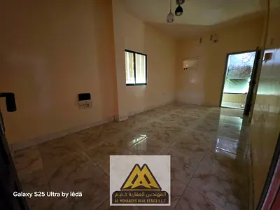 Annual Rent: Spacious studio in Al Rashidiya 1, ground floor, separate kitchen, balcony, no AC, free parking, AED 16,997, payable in 6 cheques.