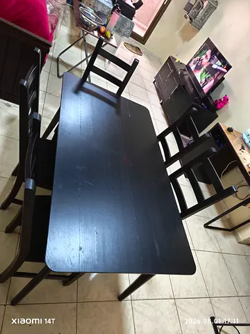 Solid wood black dining table with 5 matching chairs - good condition
