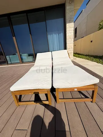 Pair of wooden outdoor sun loungers with cushions - good condition (1 pc AED200/ 2pc 300)